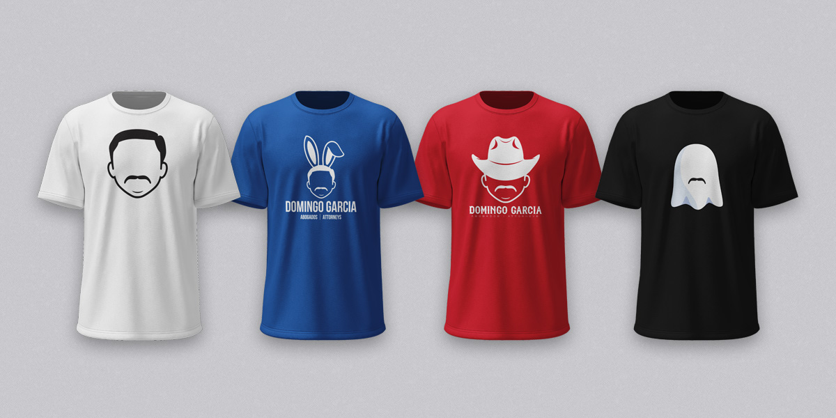 Four branded t-shirts in white, blue, red and black, each printed with the firm's illustrated portrait mark